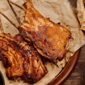 Juicy grilled chicken served with dipping sauce and vegetables. Perfect for a hearty meal.