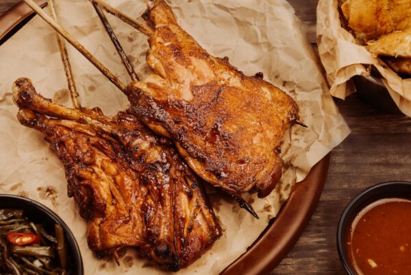 Juicy grilled chicken served with dipping sauce and vegetables. Perfect for a hearty meal.